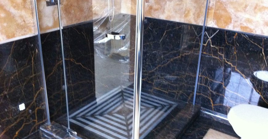 Bathroom in Gold Onyx and Port St Laurent Marble